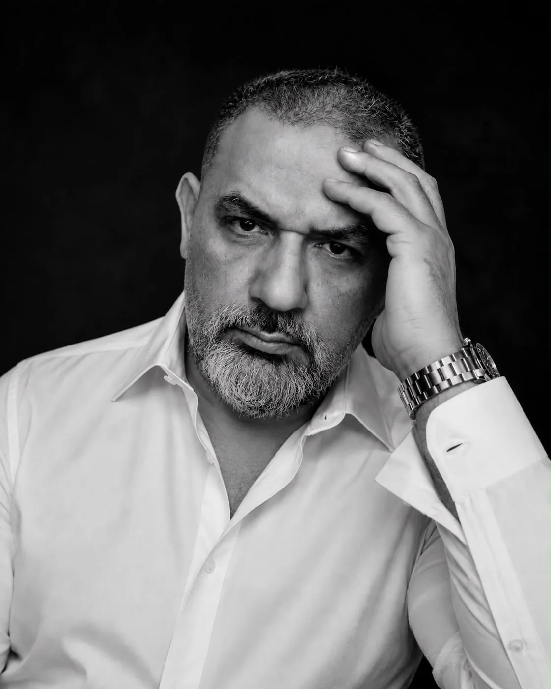 Samer Najjar, studio portrait, hand raised to his forehead