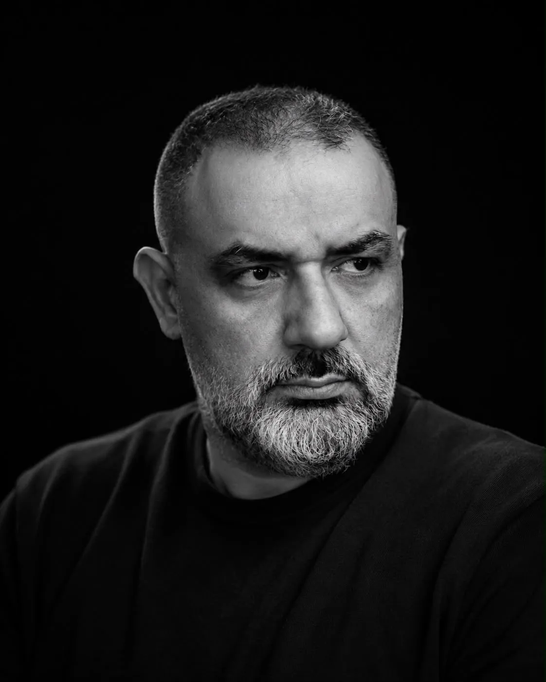Samer Najjar, three-quarter portrait against a plain dark ground